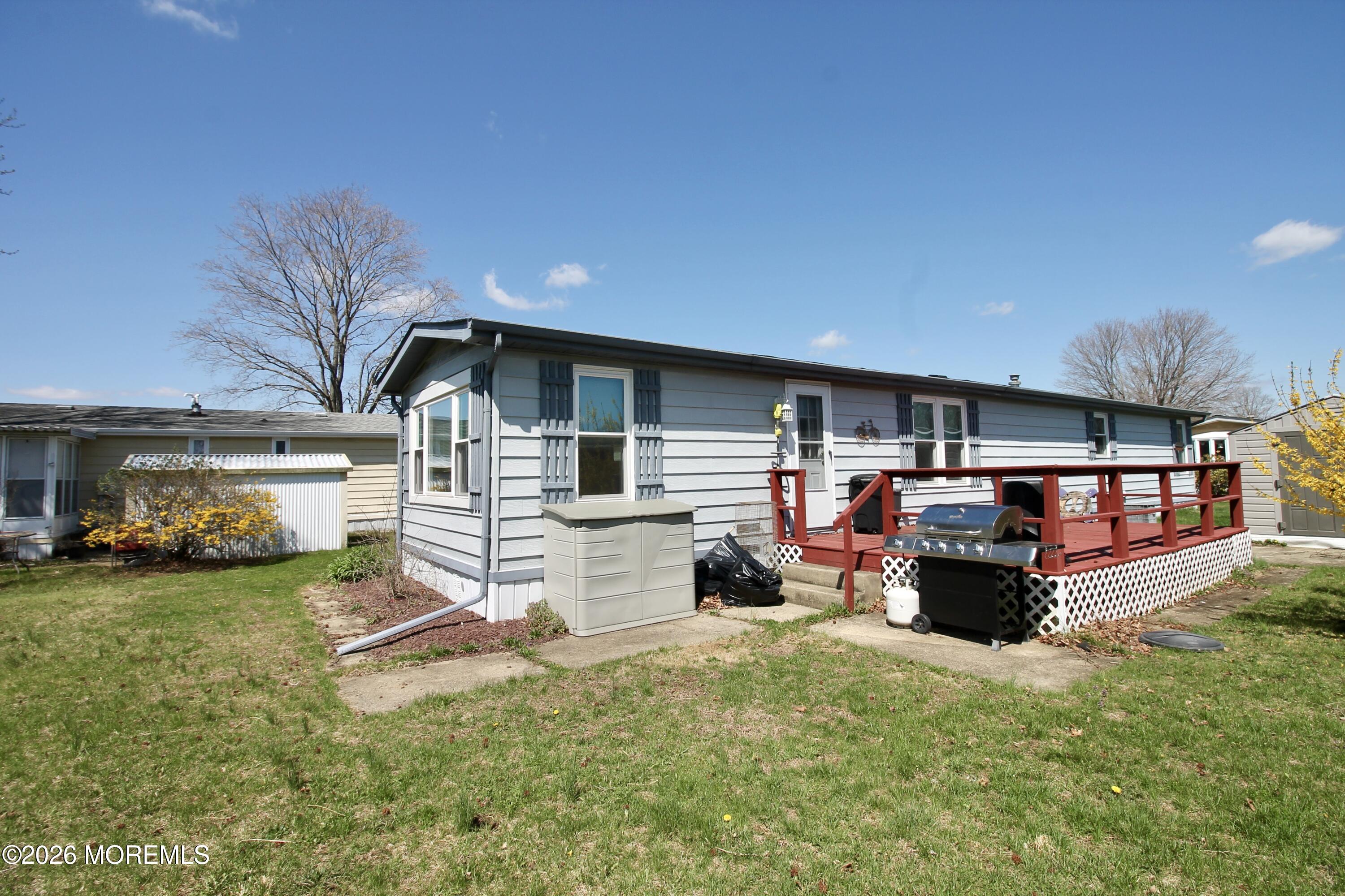623 Sara Drive Freehold, NJ 07728 - Photo 22 of 28 a view of a house with a yard and sitting area