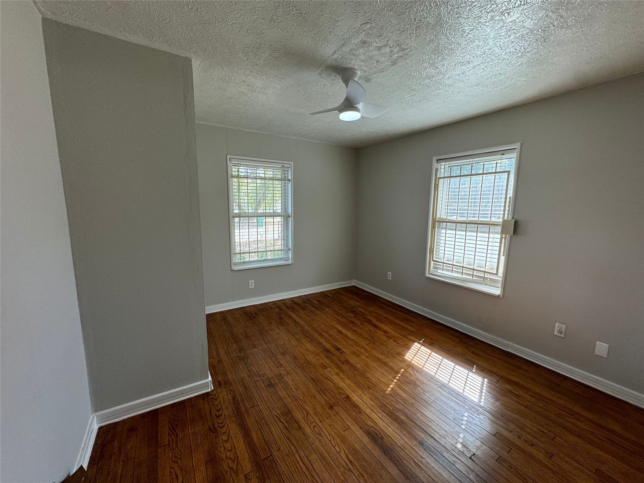 125 Pomeroy Street Pasadena, TX 77506 - Photo 18 of 19 an empty room with wooden floor and windows