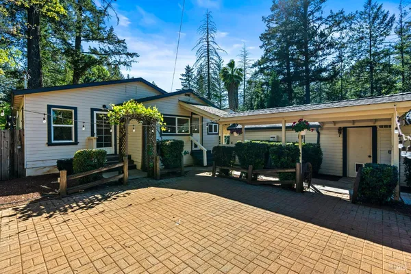 a kitchen with stainless steel appliances granite countertop a sink a stove and cabinets