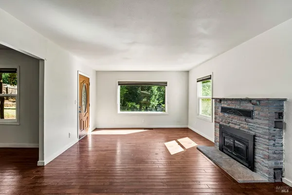 a view of entryway with a floor to ceiling window and a living room