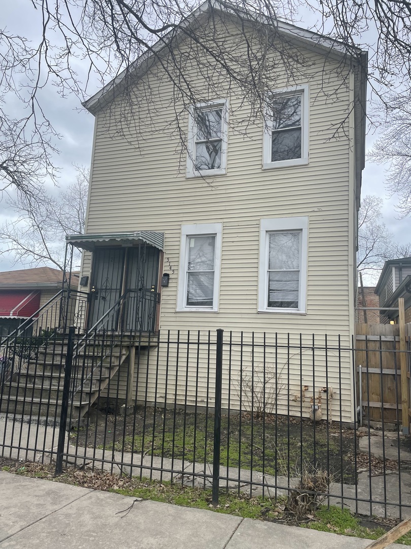 5145 South Lowe Avenue Chicago, IL 60609 - Photo 1 of 17 a view of a brick house that has a small yard