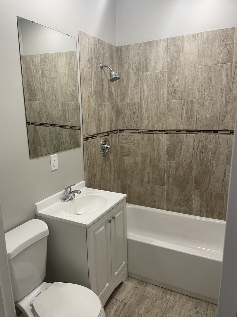 5145 South Lowe Avenue Chicago, IL 60609 - Photo 12 of 17 a bathroom with a sink a toilet and shower