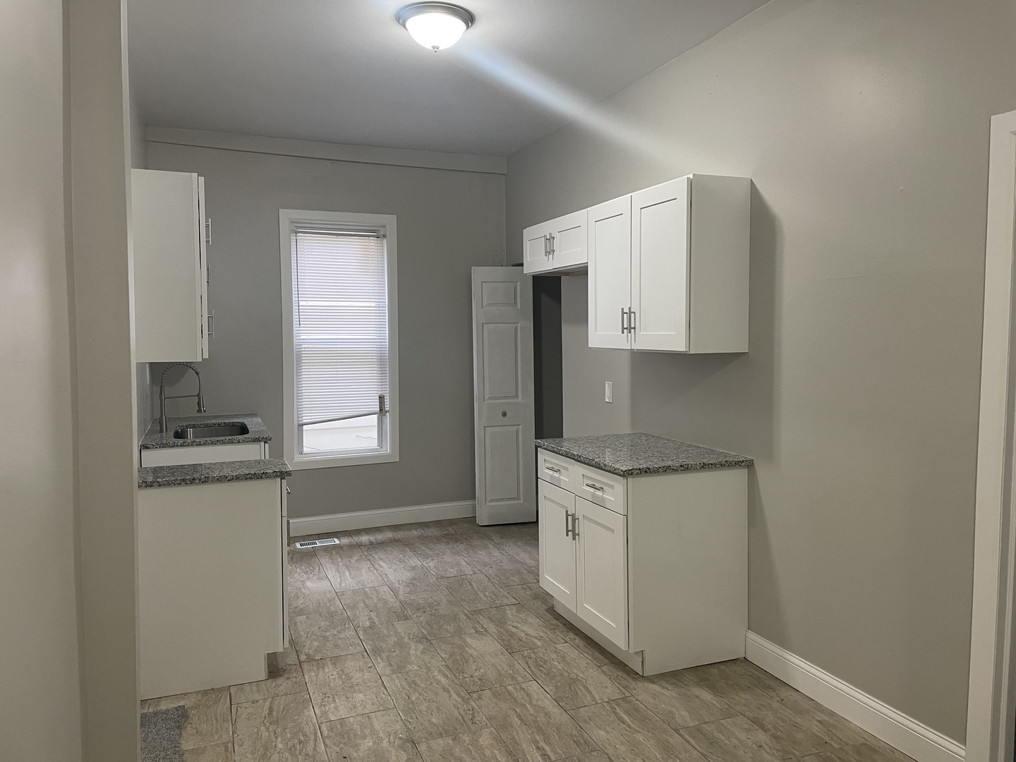 5145 South Lowe Avenue Chicago, IL 60609 - Photo 7 of 17 a kitchen with granite countertop a sink stove and refrigerator