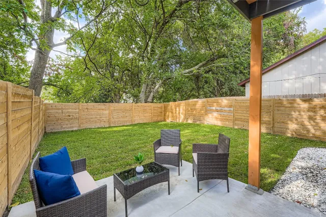 a view of backyard with seating and green space