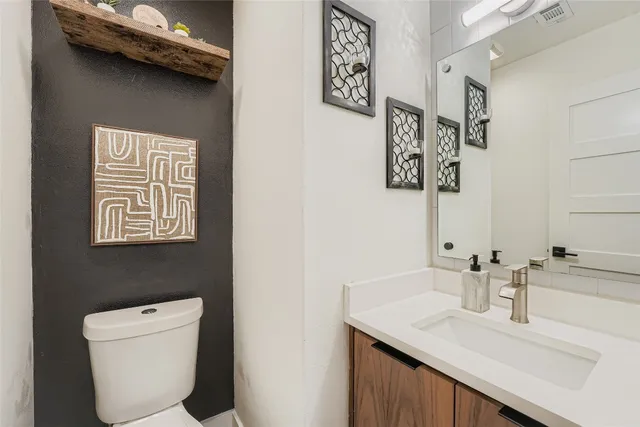 a bathroom with a toilet a sink and a mirror