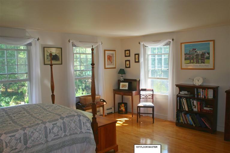 60 Slough Road Brewster, MA 02631 - Photo 8 of 22 a bedroom with a bed and a table with chair
