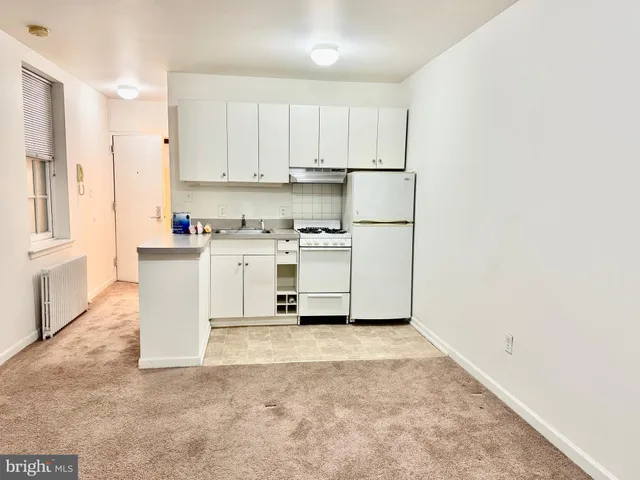 a utility room with cabinets washer and dryer