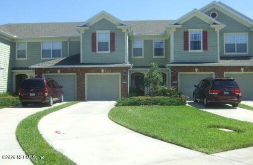 7002 Roundleaf Drive Jacksonville, FL 32258 - Photo 1 of 13 a front view of a house with a yard and garage
