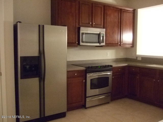 7002 Roundleaf Drive Jacksonville, FL 32258 - Photo 2 of 13 a kitchen with granite countertop stainless steel appliances and wooden cabinets