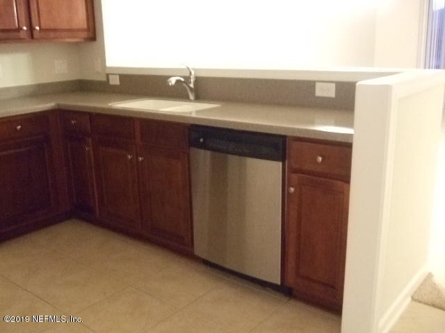 7002 Roundleaf Drive Jacksonville, FL 32258 - Photo 3 of 13 a bathroom with a sink and cabinets
