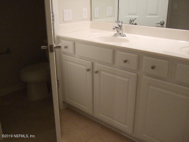 7002 Roundleaf Drive Jacksonville, FL 32258 - Photo 8 of 13 a bathroom with a sink and vanity