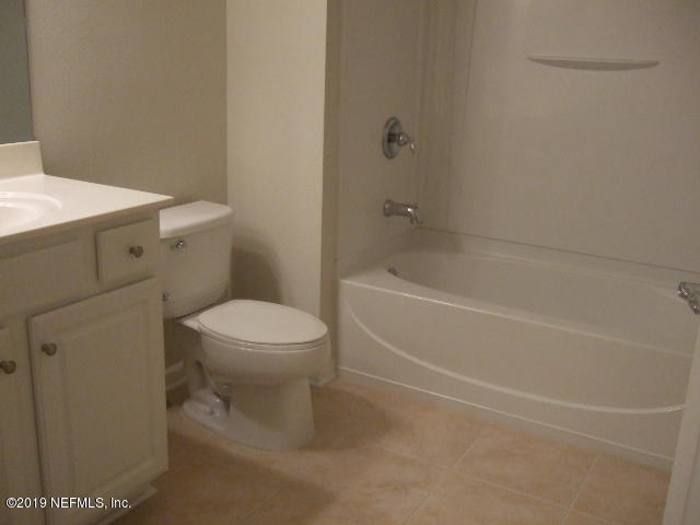 7002 Roundleaf Drive Jacksonville, FL 32258 - Photo 9 of 13 a white toilet sitting next to a bath tub