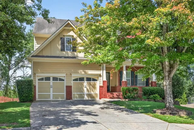 a front view of a house with a garden