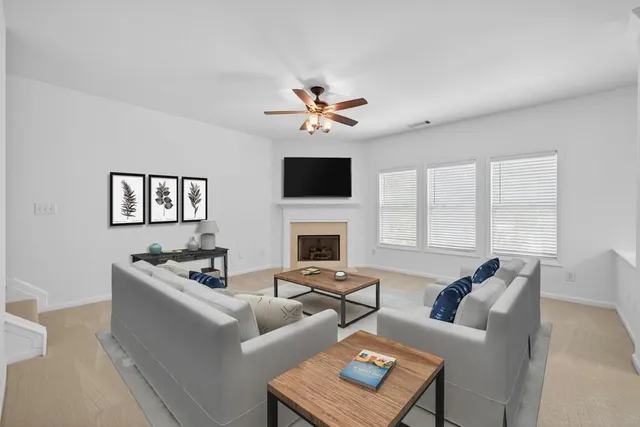 a living room with furniture a fireplace and a flat screen tv