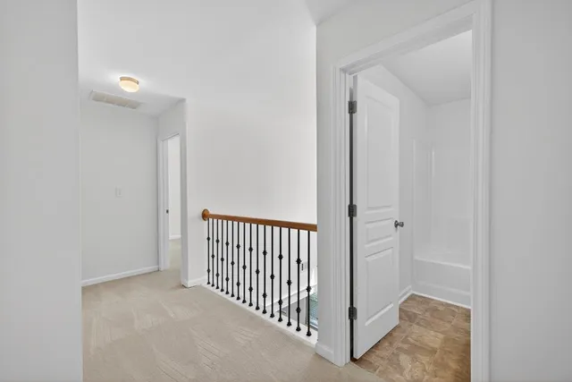 a view of a hallway with entryway door