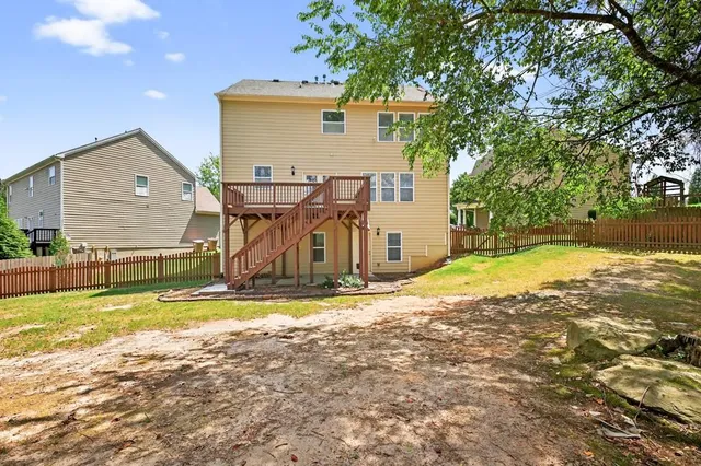 a view of a house with swimming pool and sitting area
