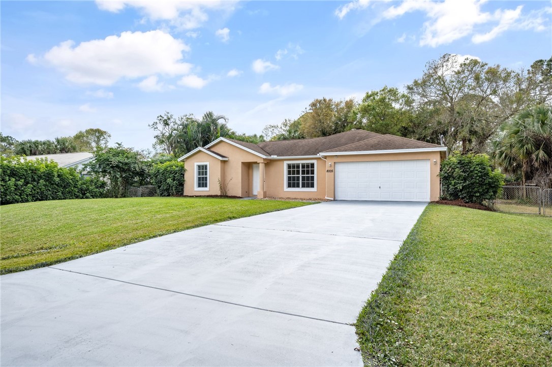 8005 Pensacola Road Fort Pierce, FL 34951 - Photo 4 of 36 a house with green field in front of it