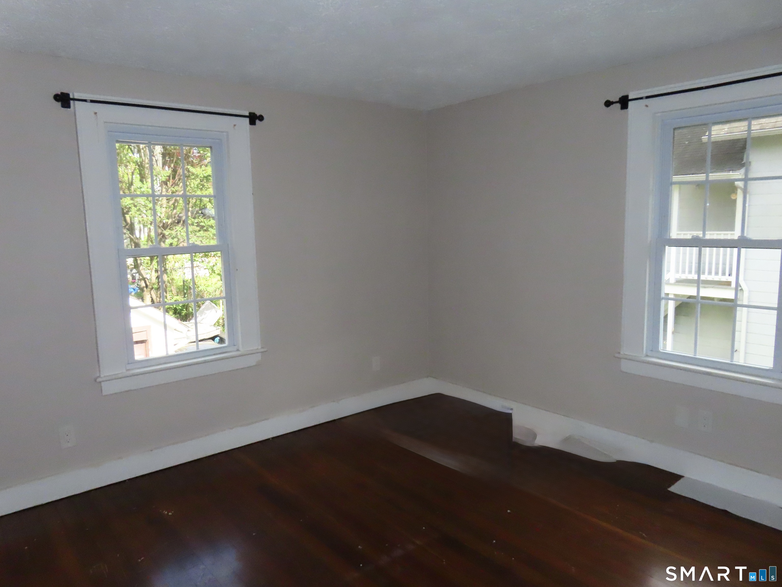 38 Winter Street Ansonia, CT 06401 - Photo 5 of 13 an empty room with wooden floor and windows