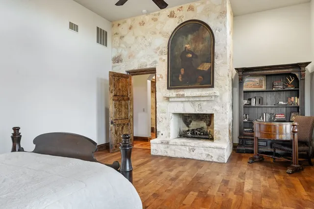 a spacious bedroom with a bed and a shower