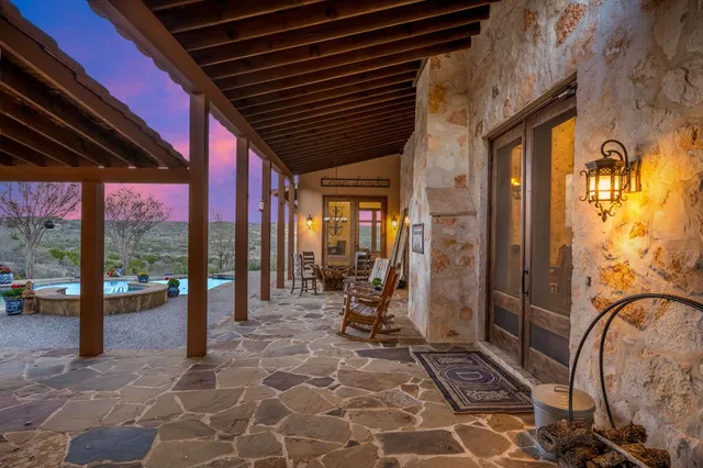 a kitchen with stainless steel appliances granite countertop a refrigerator a stove a sink dishwasher a dining table and chairs with wooden floor