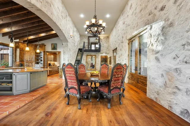a room with gym equipment and large windows