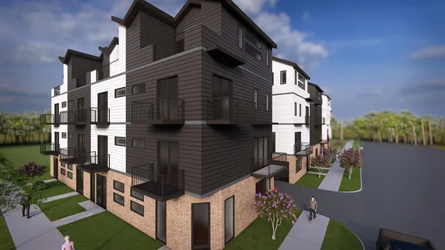 a front view of a residential apartment building with a yard