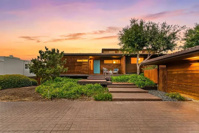 a front view of a house with a yard and a garage
