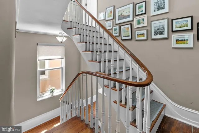 a view of staircase with wooden floor and a window