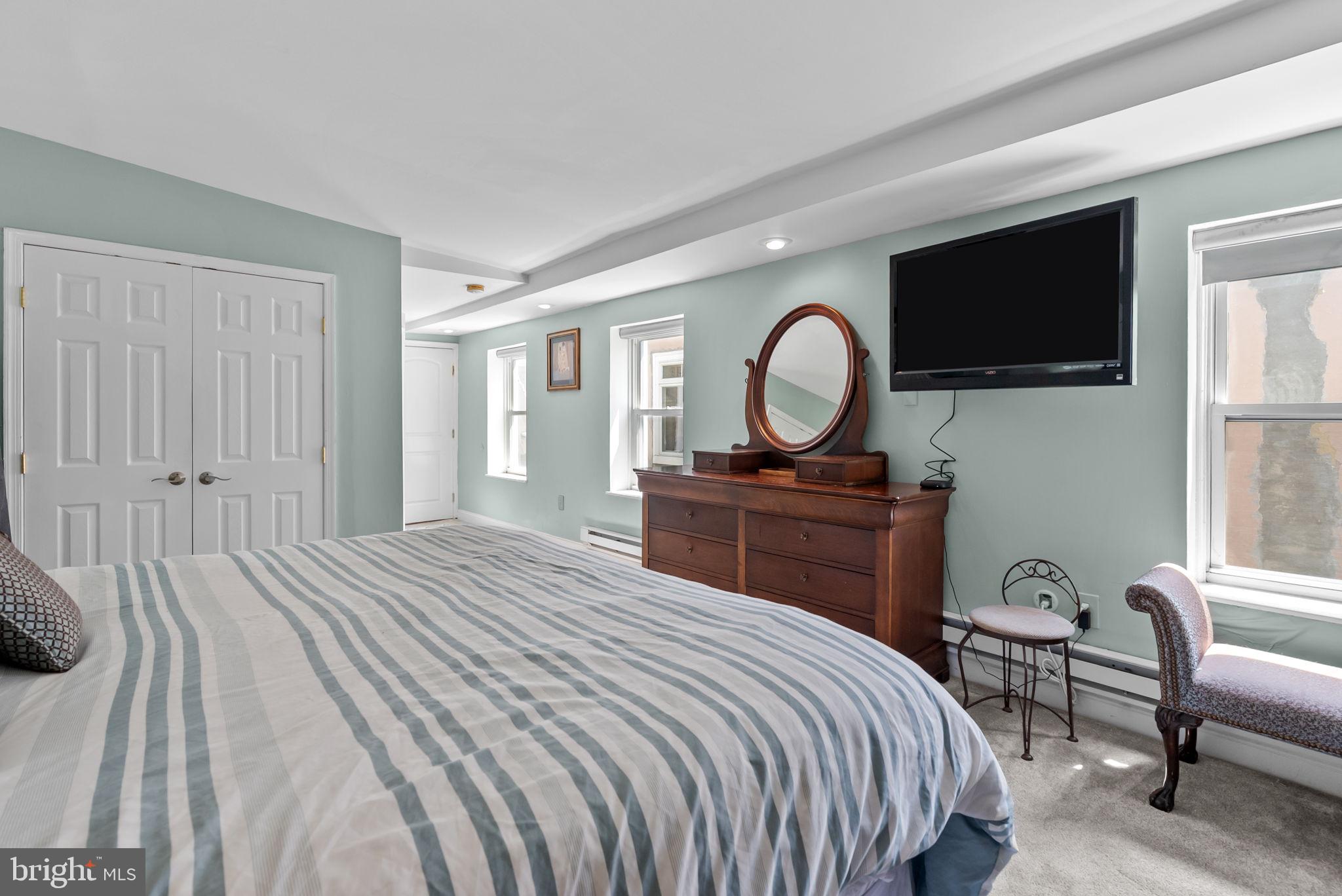 1518 Mt Vernon Street, Unit 3 Philadelphia, PA 19130 - Photo 14 of 24 a bedroom with a bed and a flat screen tv