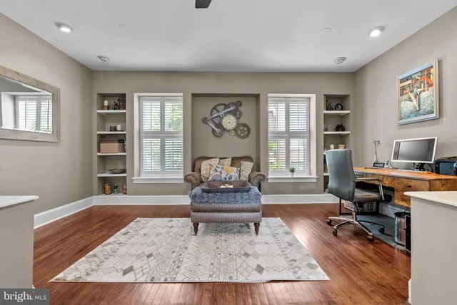 a living room with furniture window and wooden floor