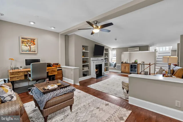 a living room with furniture and a fireplace
