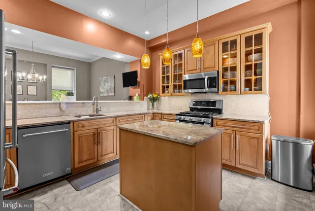 a kitchen with stainless steel appliances granite countertop a stove and a sink