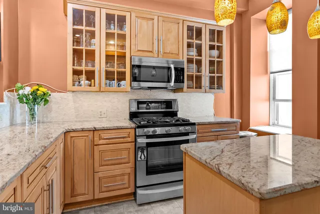 a kitchen with stainless steel appliances granite countertop a stove and a sink
