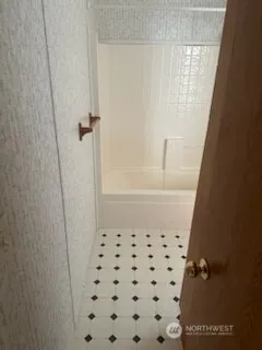 a bathroom with a bathtub and shower