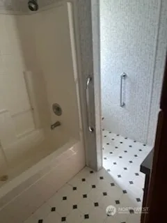 a bathroom with a sink a mirror and shower