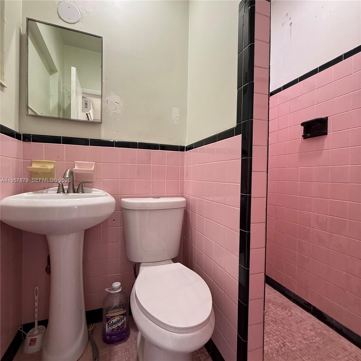 275 West 16th Street Hialeah, FL 33010 - Photo 14 of 17 a bathroom with a toilet sink and mirror