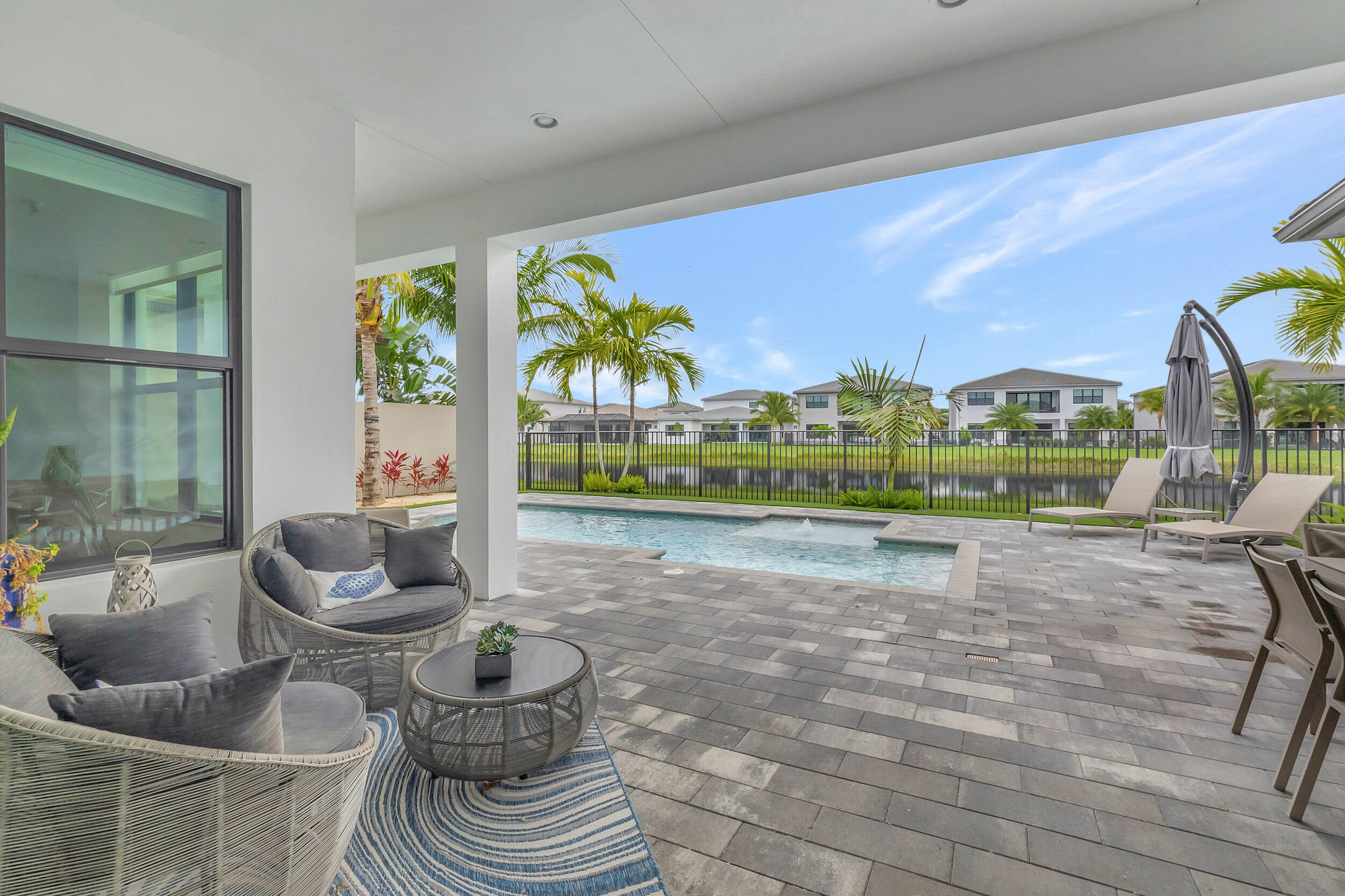 17118 Aquavera Way Boca Raton, FL 33496 - Photo 20 of 53 a living room with furniture and a floor to ceiling window