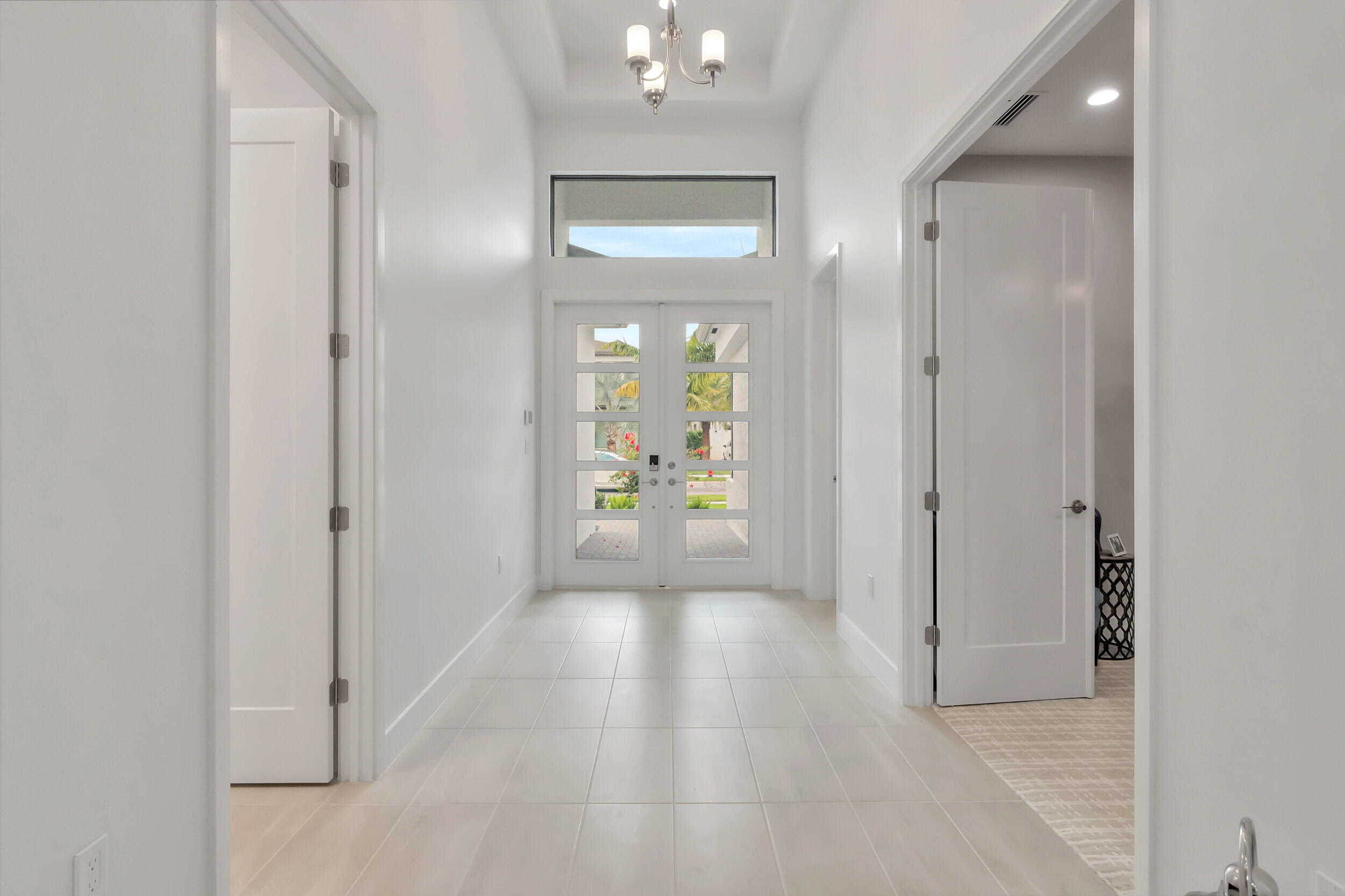 17118 Aquavera Way Boca Raton, FL 33496 - Photo 2 of 53 a view of a hallway with wooden floor