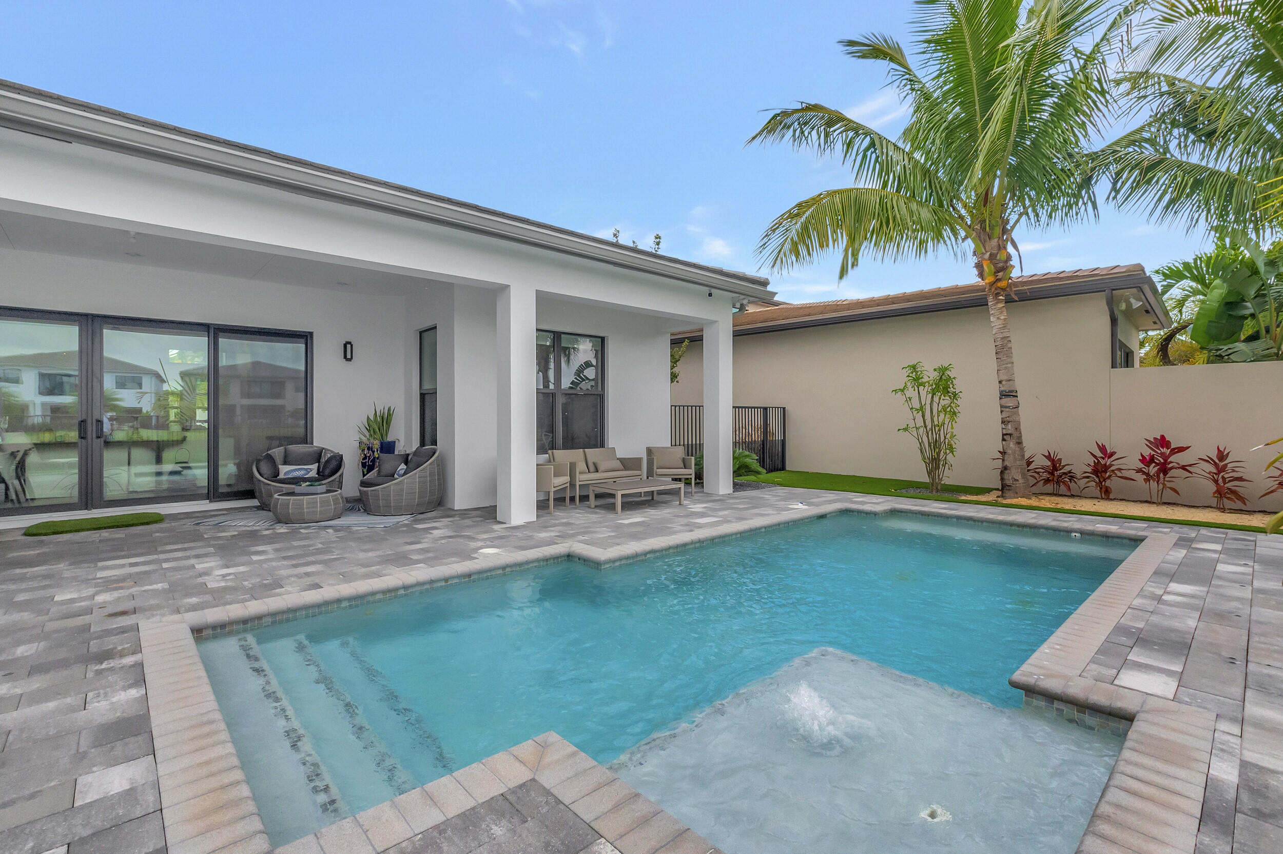 17118 Aquavera Way Boca Raton, FL 33496 - Photo 22 of 53 a view of a house with swimming pool and a porch