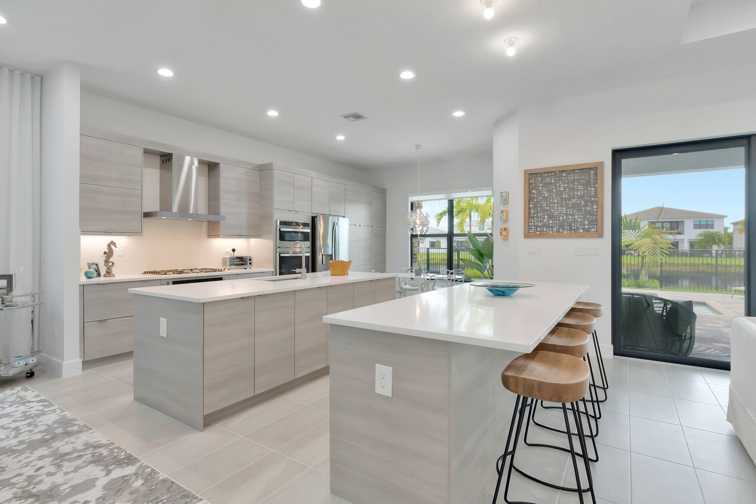 17118 Aquavera Way Boca Raton, FL 33496 - Photo 6 of 53 a kitchen with stainless steel appliances granite countertop a sink and a stove