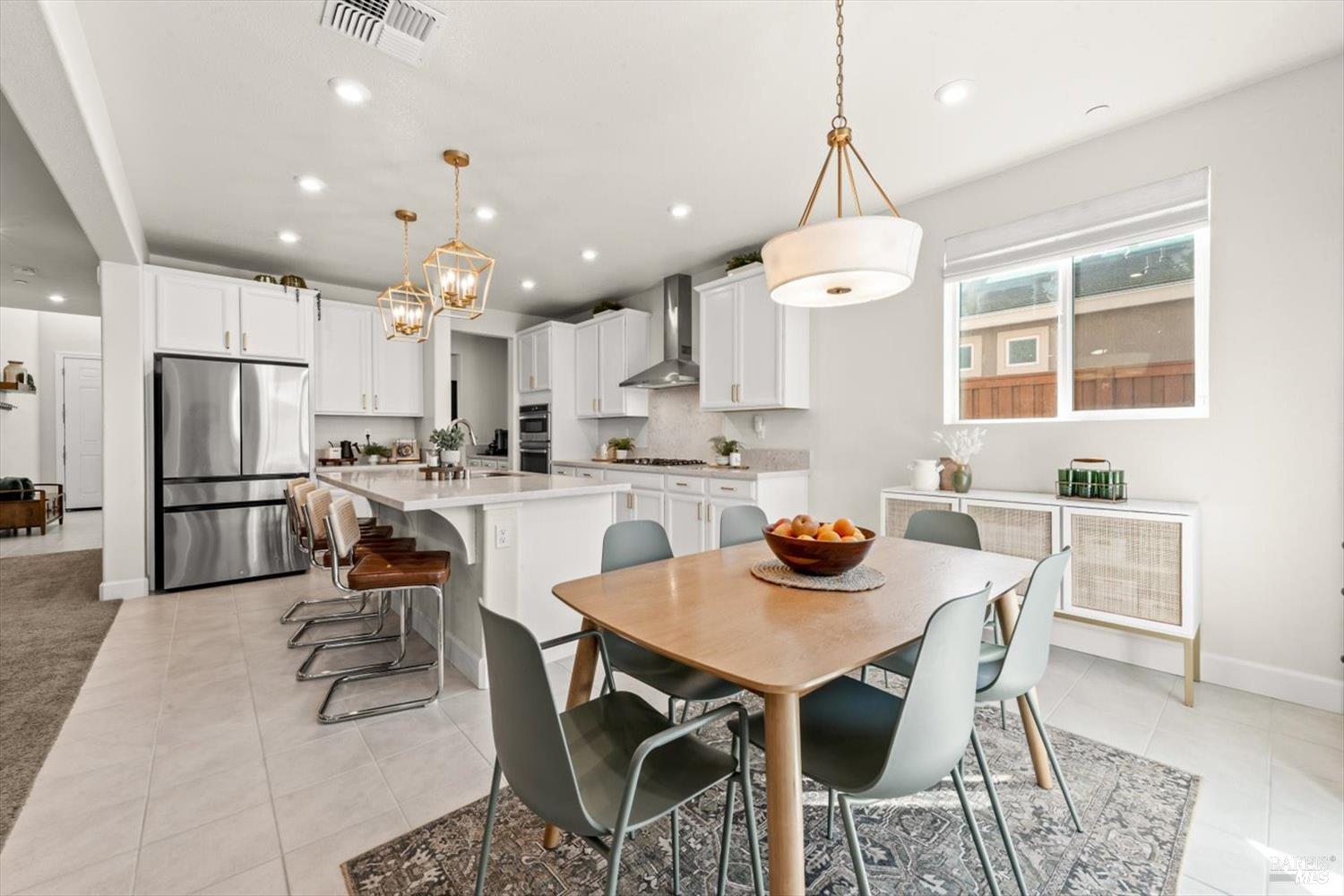 710 Fielding Way Dixon, CA 95620 - Photo 30 of 104 a dining room with stainless steel appliances a table and chairs