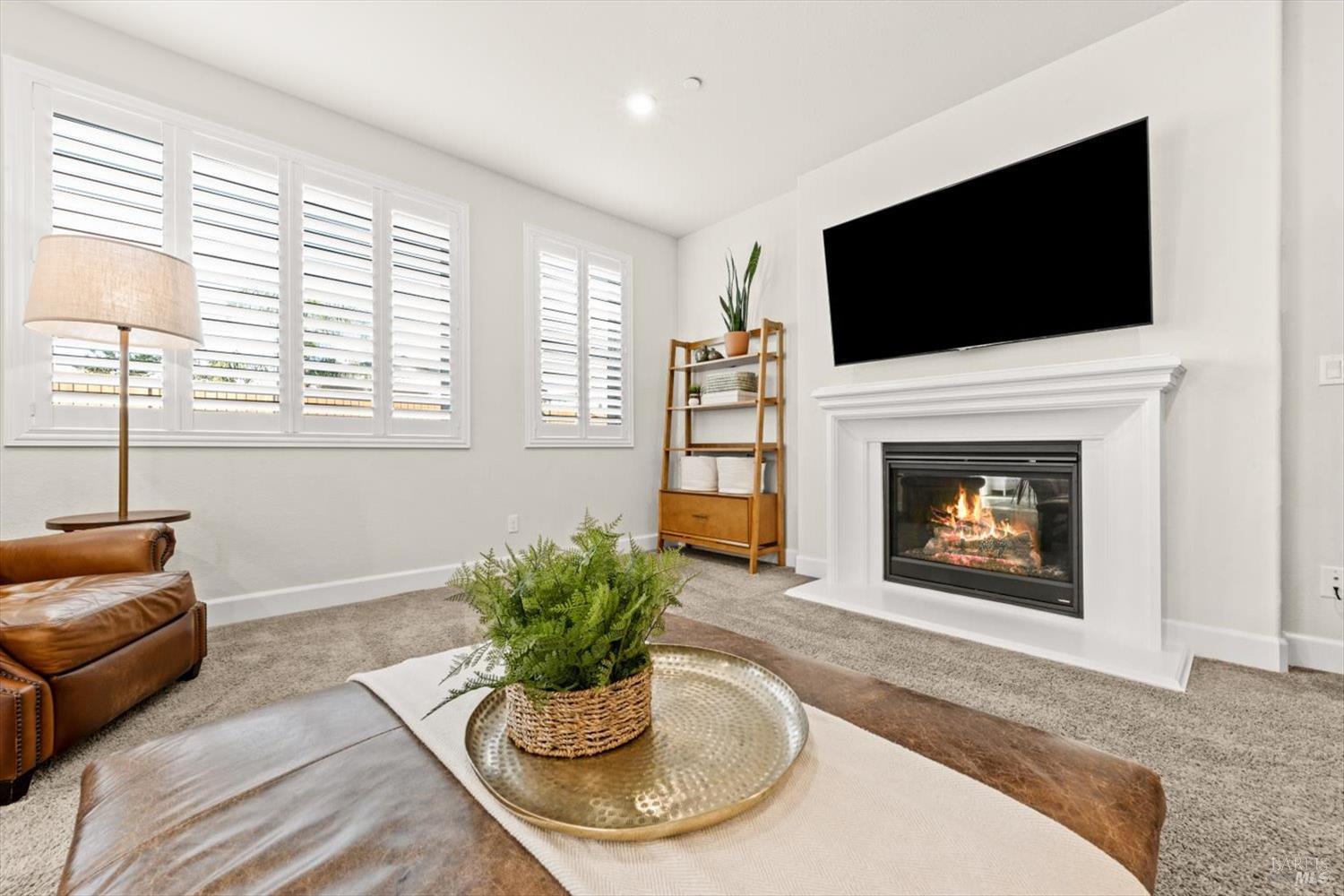 710 Fielding Way Dixon, CA 95620 - Photo 44 of 104 a living room with furniture a flat screen tv and a fireplace