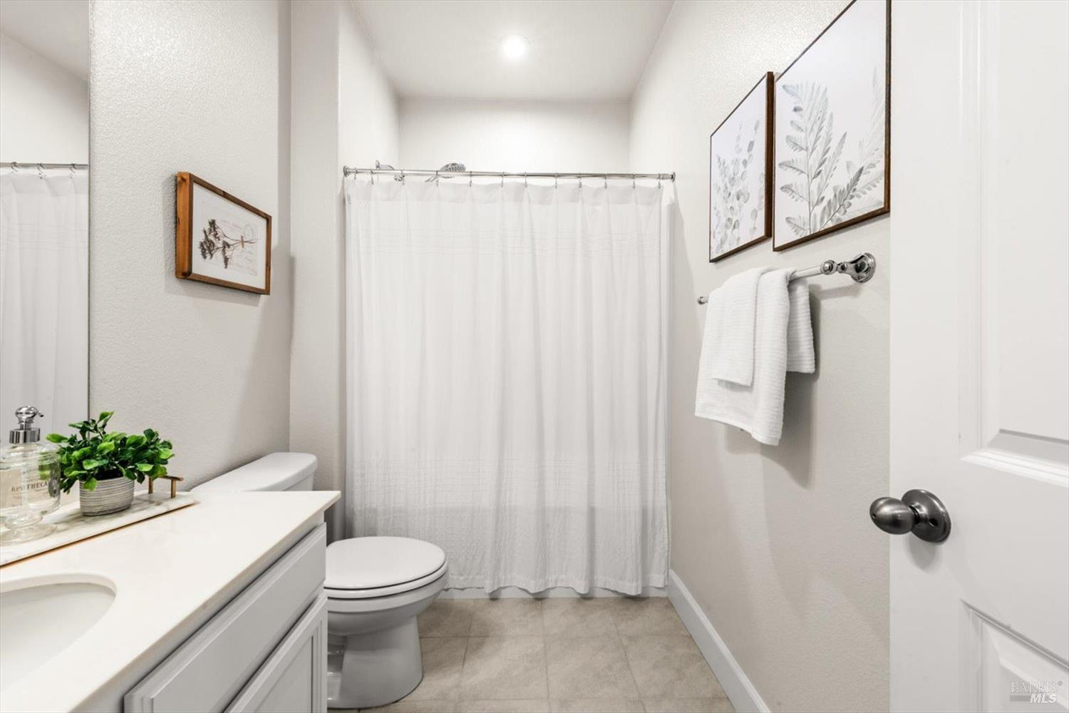 710 Fielding Way Dixon, CA 95620 - Photo 50 of 104 a white toilet sitting next to a shower curtain