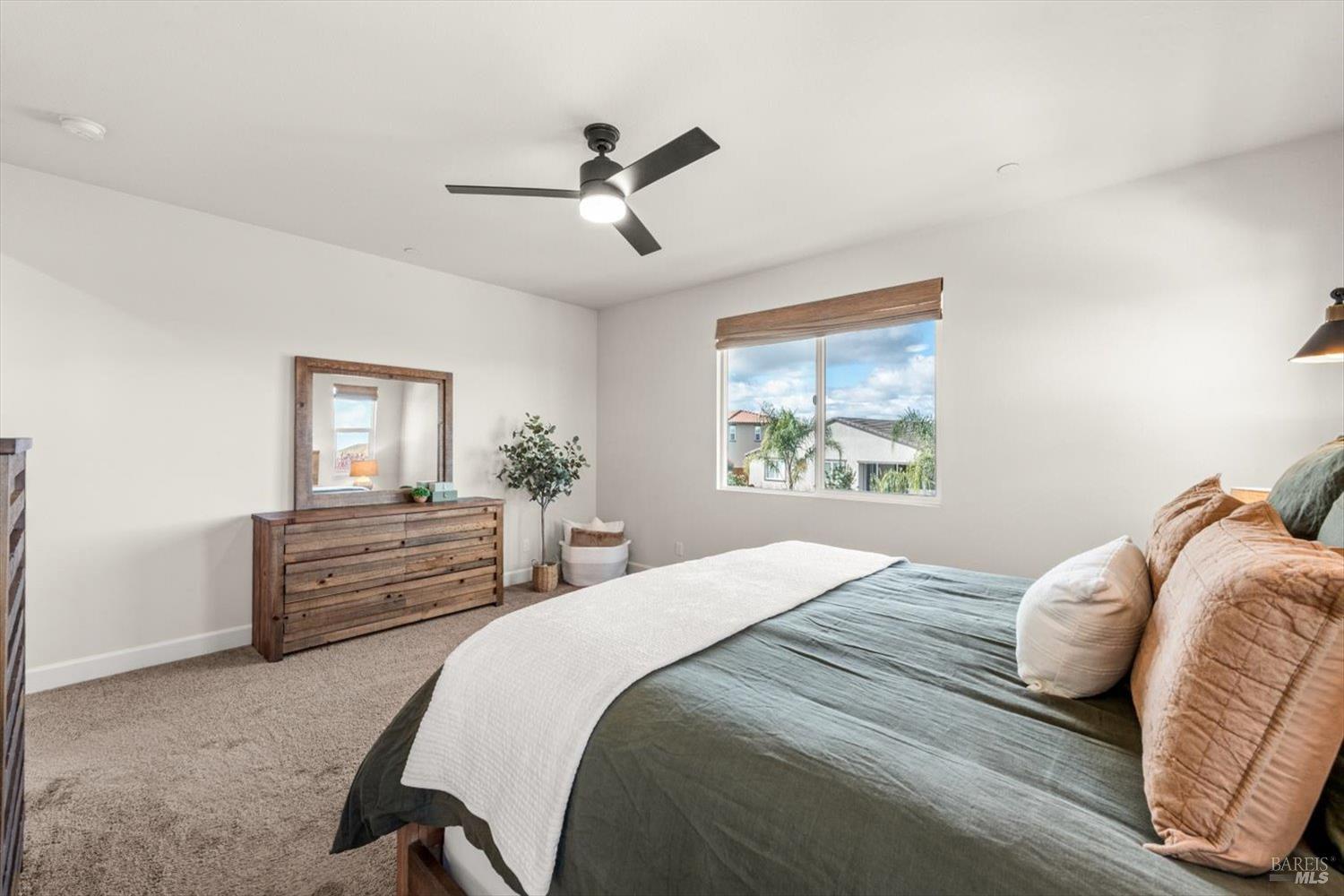710 Fielding Way Dixon, CA 95620 - Photo 61 of 104 a bedroom with a large bed and a chandelier