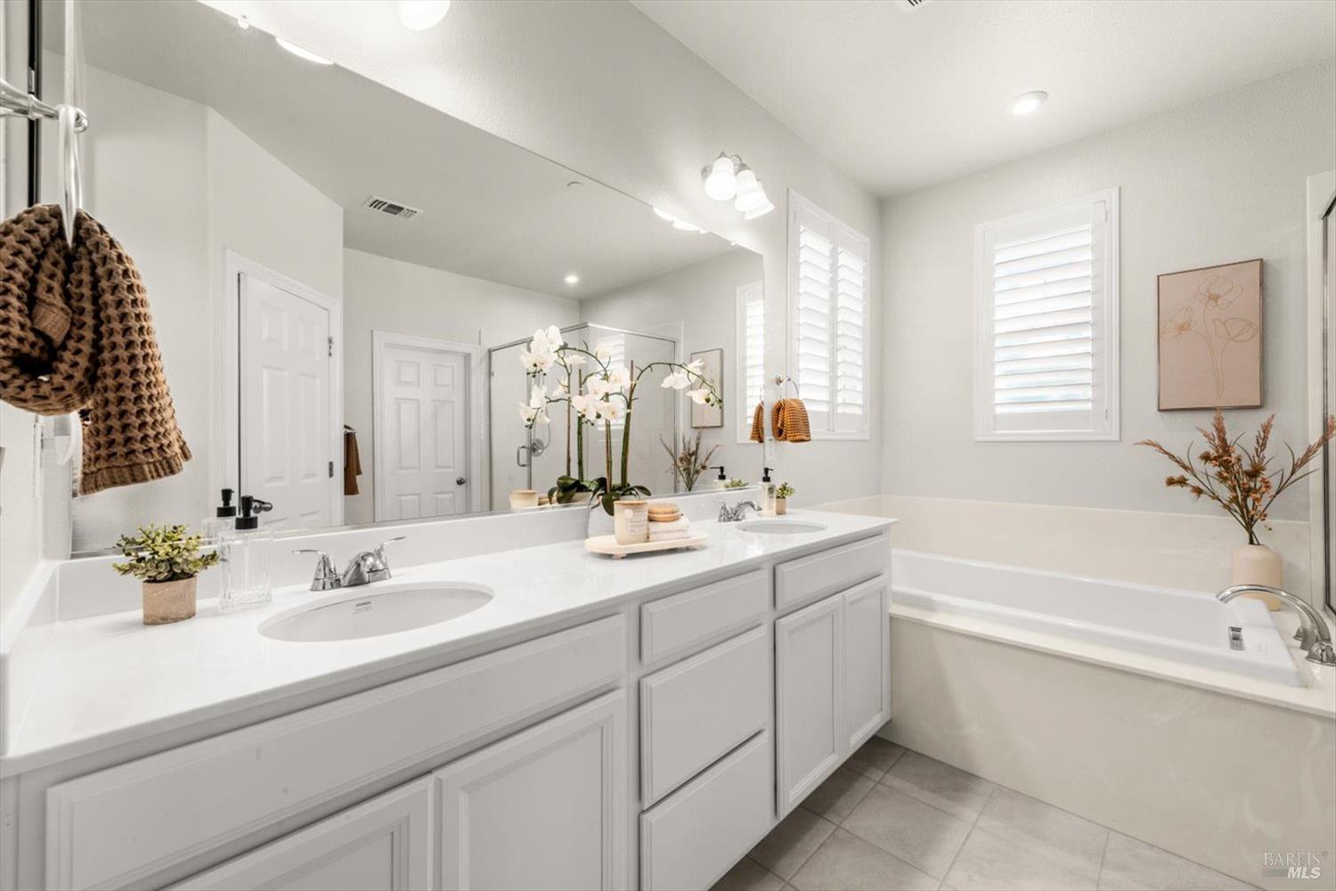 710 Fielding Way Dixon, CA 95620 - Photo 63 of 104 a bathroom with a sink double vanity granite tub shower and a mirror