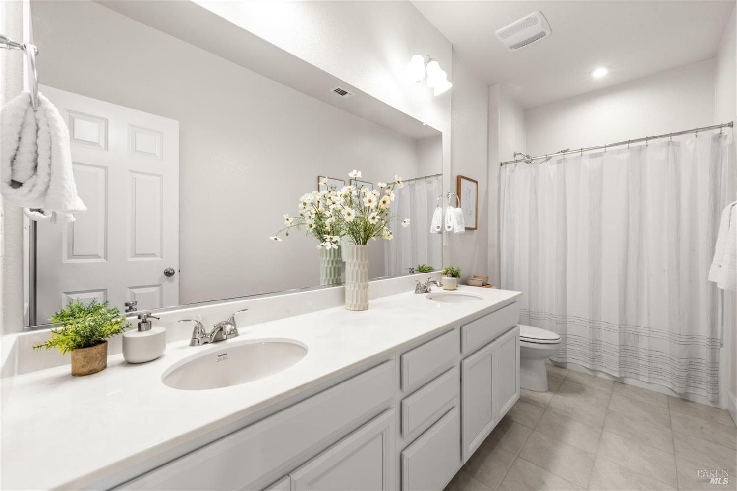 710 Fielding Way Dixon, CA 95620 - Photo 75 of 104 a bathroom with a double vanity sink and a mirror