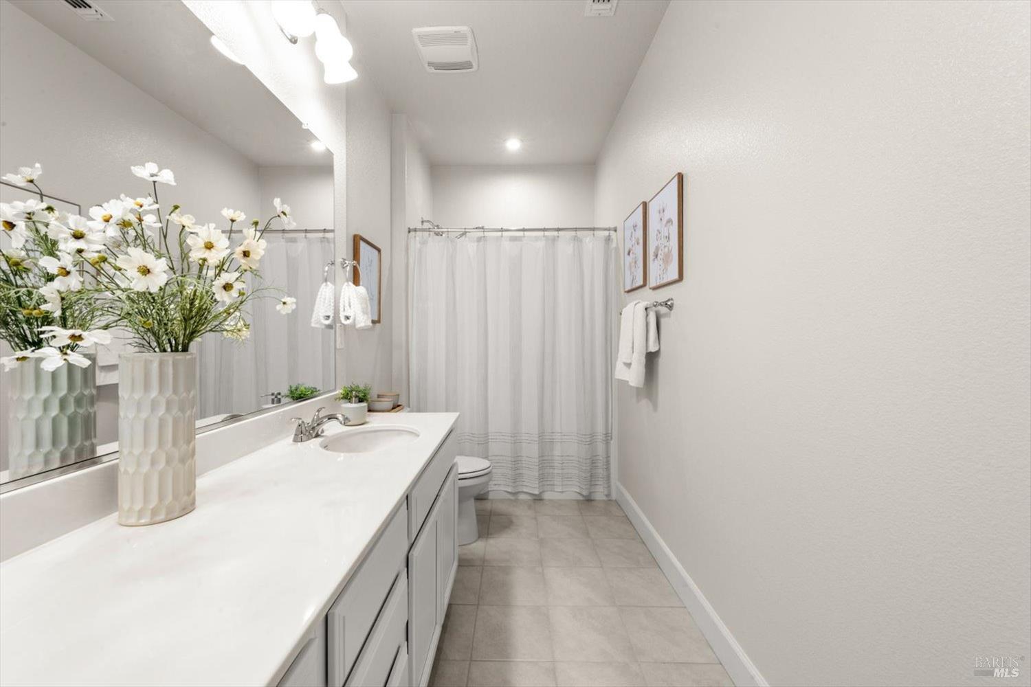 710 Fielding Way Dixon, CA 95620 - Photo 76 of 104 a bathroom with a sink a shower and a mirror