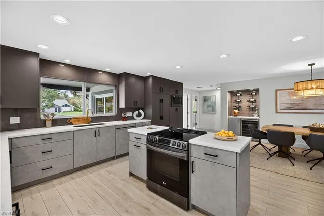 a kitchen that has a lot of cabinets in it and wooden floors