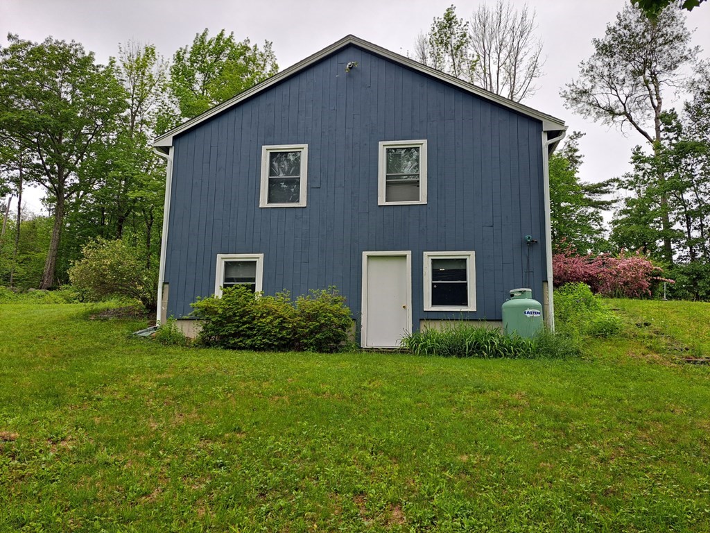77 Collins Road New Ipswich, NH 03071 - Photo 6 of 26 a house that is sitting in the grass