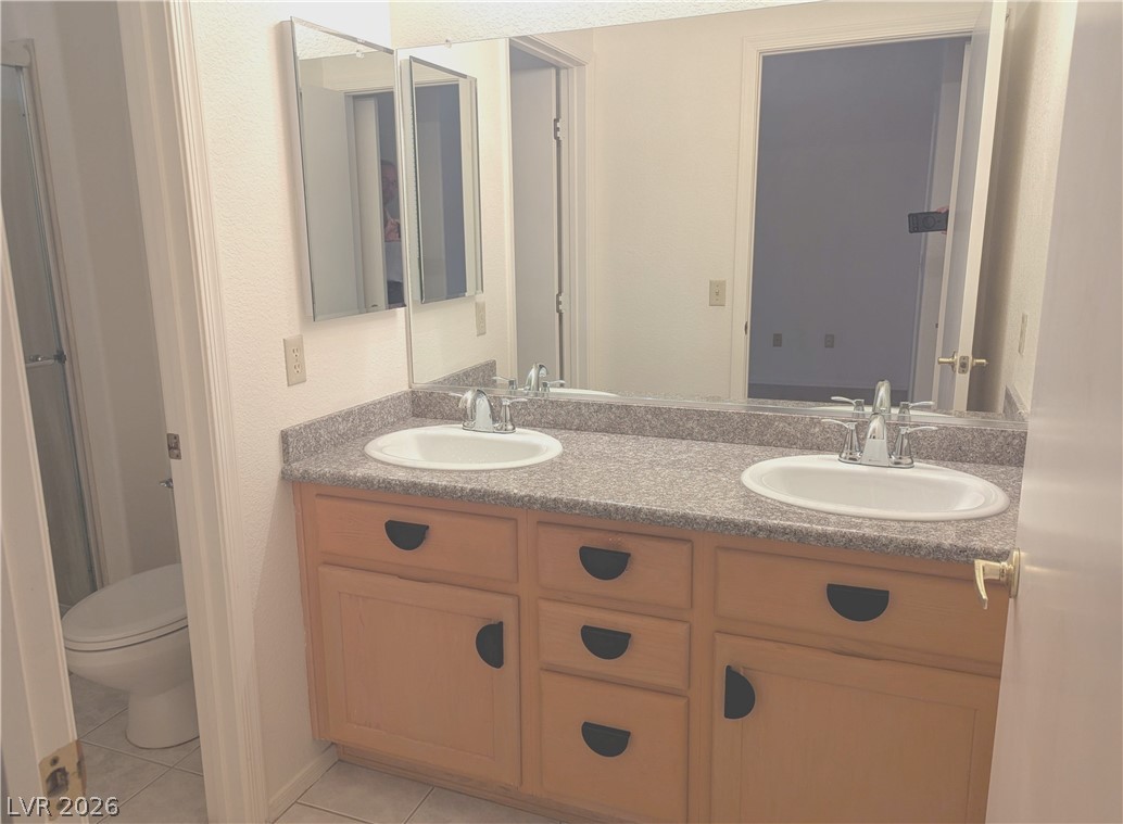 9433 Quail Ridge Drive Las Vegas, NV 89134 - Photo 10 of 23 Double vanities with sleek countertops and ample storage enhance this well-appointed bath.